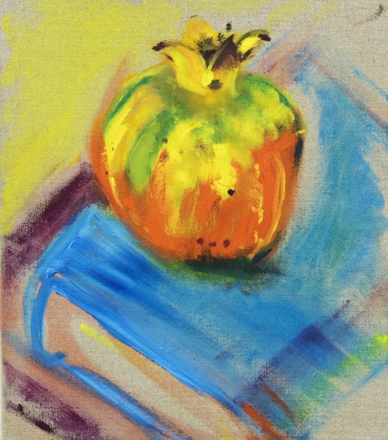Still life of a pomegranate on a blue book